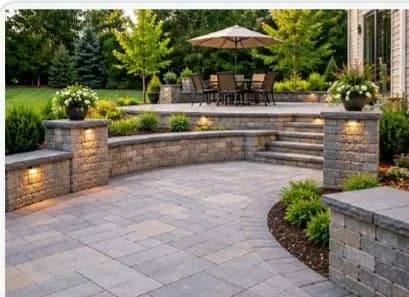 Block retaining wall with stone steps on a slope